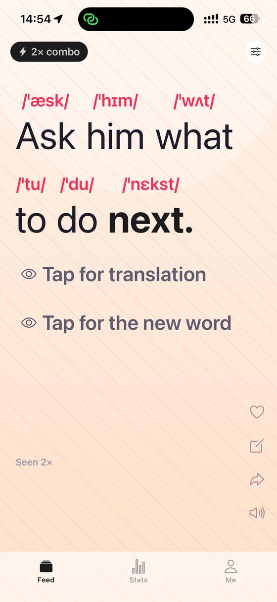 A sentence card on a warm reading background: "Ask him what to do next." with IPA printed above every word and "next" set in bold as the new word.